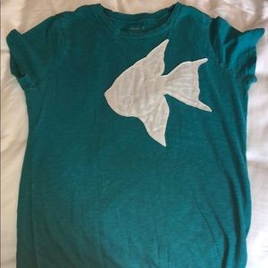teal shirt with white fish